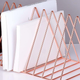 Since everything looks better in rose gold, this magazine rack is a stylish way to hold eight of your favorite albums.